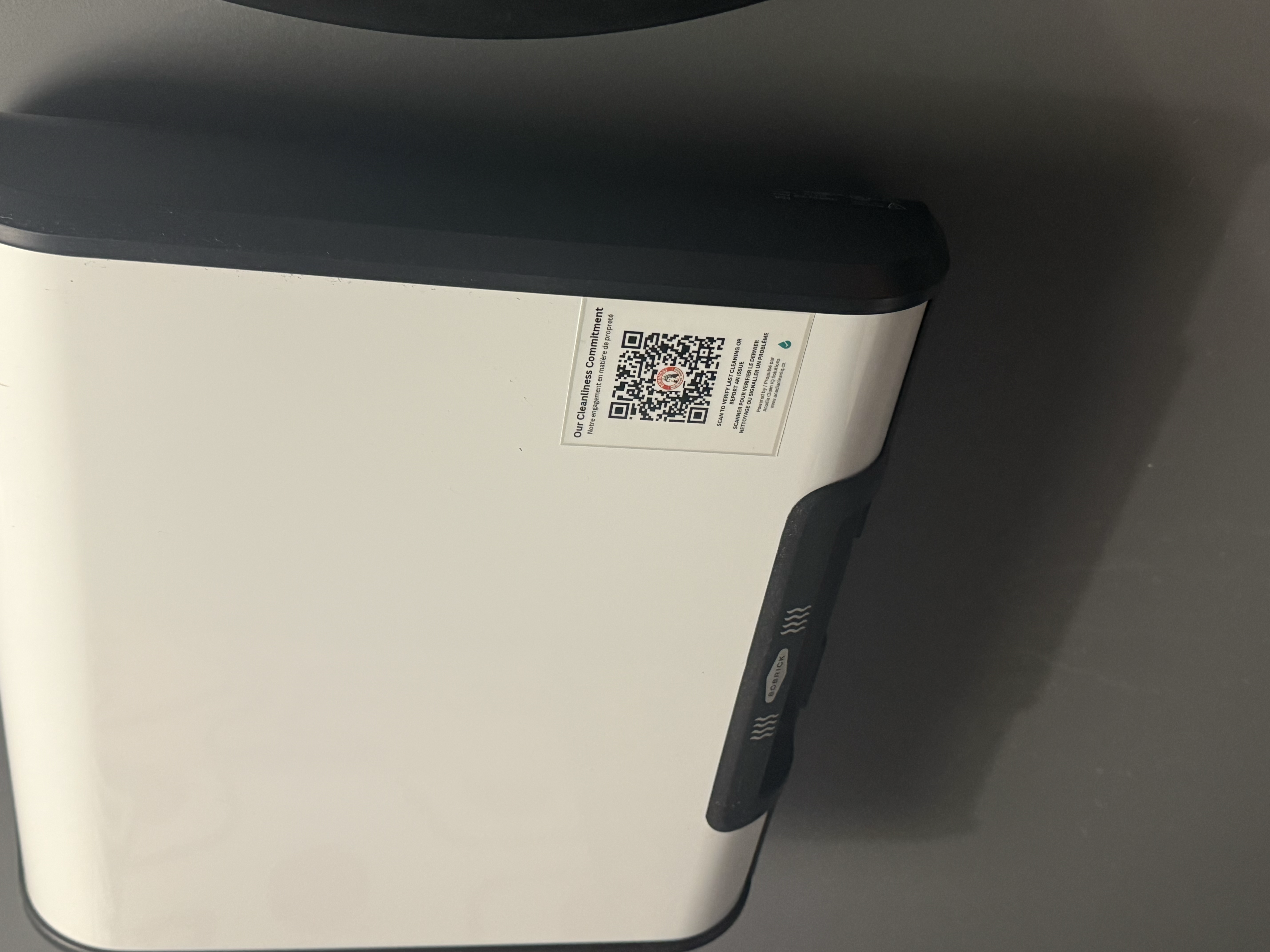 Acadia CleanIQ QR code mounted on a facility dispenser in Moncton, NB